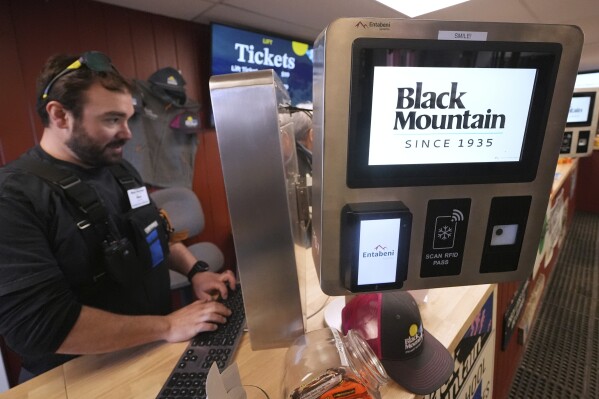 A digital terminal displays the Black Mountain logo at the lift ticket point of sale location at the base of the mountain, Friday, March 14, 2025, in Jackson, N.H. (AP Photo/Charles Krupa)