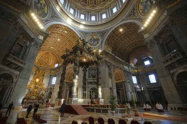 Staff make final preparations in St. Peter's Basilica ahead of the arrival of the body of Pope Francis, who will lie in state for three days, at the Vatican, Wednesday, April 23, 2025. (AP Photo/Alessandra Tarantino)
