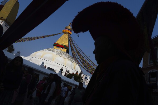 A Buddhist monk circumambulates the Boudhanath stupa during Buddha Jayanti, also known as Buddha Purnima festival, to celebrate Buddha's birthday, in Kathmandu, Nepal, Monday, May 12, 2025. (AP Photo/Niranjan Shrestha)