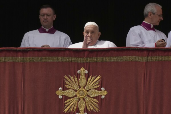 Pope Francis appears on the central lodge of St. Peter's Basilica to bestow the Urbi et Orbi (Latin for to the city and the world) blessing at the end of the Easter mass presided over by Cardinal Angelo Comastri in St. Peter's Square at the Vatican Sunday, April 20, 2025. (AP Photo/Andrew Medichini)