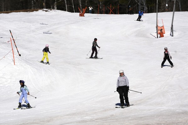 Skiers ride downhill at Black Mountain, Friday, March 14, 2025, in Jackson, N.H. (AP Photo/Charles Krupa)