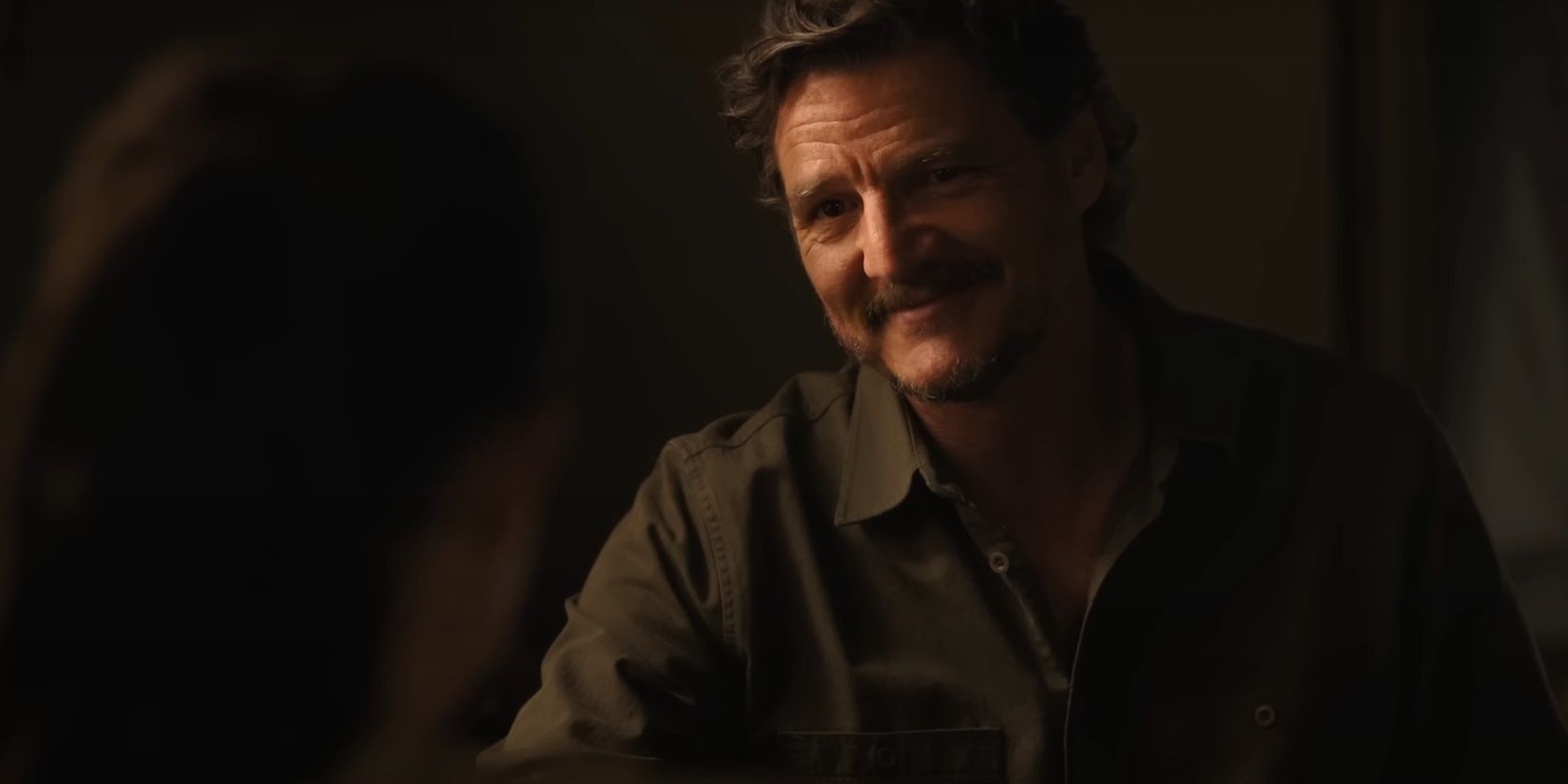 Joel smiling at Ellie in The Last of Us