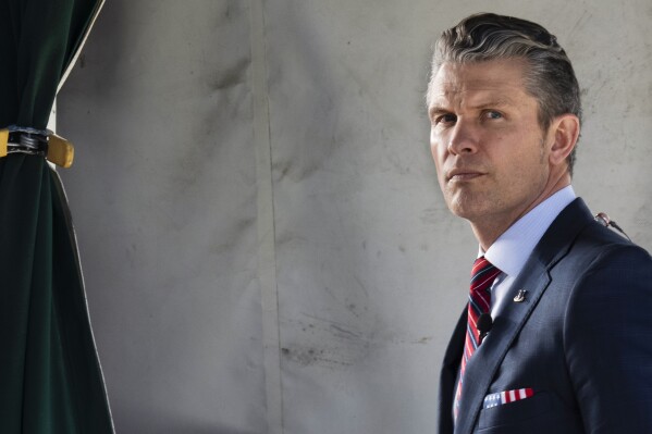 Defense Secretary Pete Hegseth does a television interview outside the White House, Friday, March 21, 2025, in Washington. (AP Photo/Jacquelyn Martin)