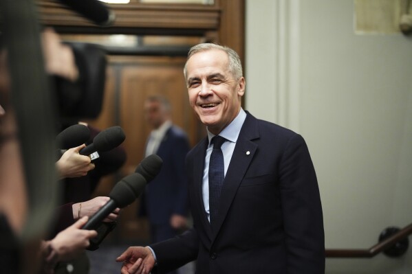 Canada Liberal Leader Mark Carney talks to the media as he leaves the prime minister's office and makes his way to a caucus meeting in Ottawa on March 10, 2025. (Sean Kilpatrick/The Canadian Press via AP, File)