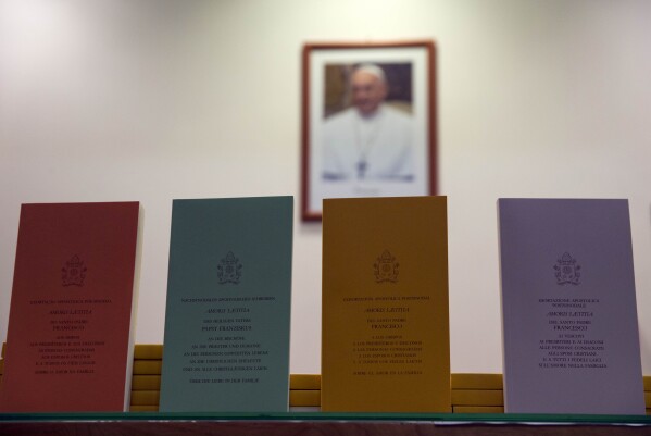 Copies of the post-synodal apostolic exhortation ' Amoris Laetitia ' (The Joy of Love) document are on display prior to the start of a press conference, at the Vatican, Friday, April 8, 2016. Pope Francis has insisted that individual conscience be the guiding principle for Catholics negotiating the complexities of sex, marriage and family life in a major document released Friday that repudiates the centrality of black and white rules for the faithful. In the 256-page document 