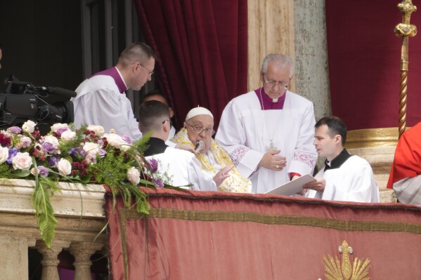 Pope Francis bestows the Urbi et Orbi (Latin for to the city and to the world) blessing from the central lodge of St. Peter's Basilica at the end of the Easter mass presided over by Cardinal Angelo Comastri in St. Peter's Square at the Vatican Sunday, April 20, 2025. (AP Photo/Gregorio Borgia)