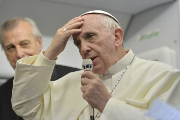Pope Francis speaks during a news conference aboard the papal flight on its way back from Brazil, Monday, July 29, 2013. Pope Francis reached out to gays on Monday, saying he wouldn't judge priests for their sexual orientation in a remarkably open and wide-ranging news conference as he returned from his first foreign trip. 