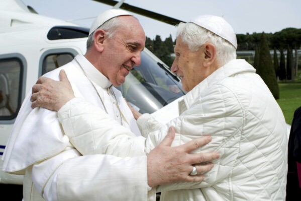 In this Saturday, March 23, 2013 photo provided by the Vatican paper L'Osservatore Romano, Pope Francis, left, meets Pope emeritus Benedict XVI in Castel Gandolfo Saturday, March 23, 2013. Emeritus Pope Benedict XVI has emerged from his self-imposed silence inside the Vatican to publish a lengthy letter to one of Italy's most well-known atheists. In it, he defends his record on handling sexually abusive priests and discusses everything from evolution to theology to the figure of Jesus Christ. Excerpts of the letter were published Tuesday, Sept. 24, 2013 by La Repubblica, the same newspaper which just two weeks ago published a similar letter from Pope Francis to its own atheist publisher. The letters indicate the two men in white, who live across the Vatican gardens from one another, are pursuing a collaborative campaign of sorts to engage non-believers. (AP Photo/Osservatore Romano, Files)
