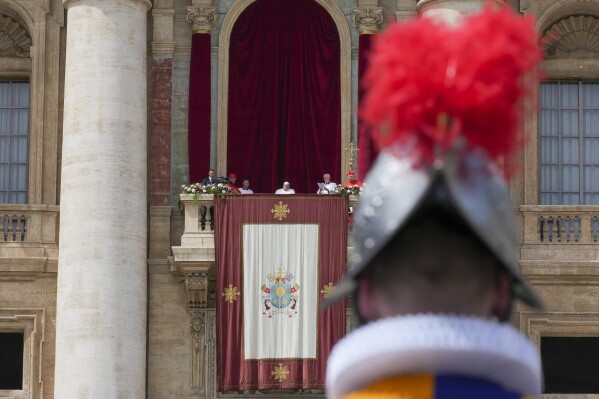 Pope Francis appears on the central lodge of St. Peter's Basilica to bestow the Urbi et Orbi (Latin for to the city and to the world) blessing at the end of the Easter mass presided over by Cardinal Angelo Comastri in St. Peter's Square at the Vatican Sunday, April 20, 2025. (AP Photo/Andrew Medichini)