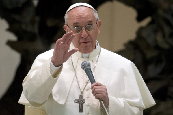 Pope Francis speaks during a meeting with the media at the Pope VI hall, at the Vatican, Saturday, March 16, 2013. Pope Francis offered intimate insights Saturday into the moments after his papal election, telling an audience with the press that he was immediately inspired to take the name of St. Francis of Assisi because of his work for peace and the poor, and was embraced by another cardinal amid applause inside the conclave. (AP Photo/Michael Sohn)
