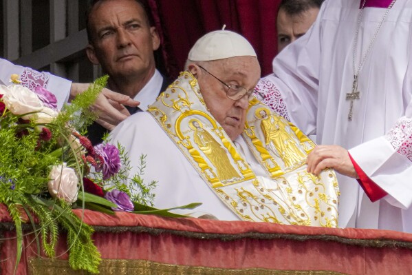Pope Francis appears on the central lodge of St. Peter's Basilica to bestow the Urbi et Orbi (Latin for to the city and to the world) blessing at the end of the Easter mass presided over by Cardinal Angelo Comastri in St. Peter's Square at the Vatican Sunday, April 20, 2025.(AP Photo/Gregorio Borgia)