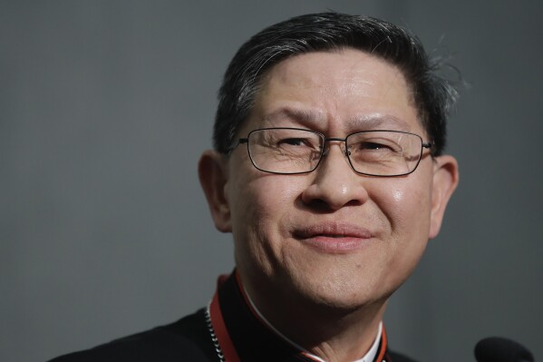 Cardinal Luis Tagle smiles as he listens reporters questions during a press conference on the Synod at the Vatican, Tuesday, Oct. 23, 2018. (AP Photo/Alessandra Tarantino, File)