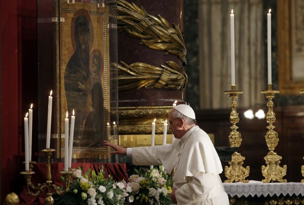 Pope Francis touches an icon of the Virgin Mary after he recited the holy rosary at the St. Mary Major Basilica, in Rome, Saturday, May 4, 2013. (AP Photo/Gregorio Borgia, file)