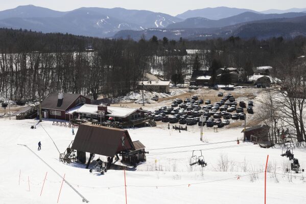 Cars are parked near a lift at the base of the Black Mountain ski area, Friday, March 14, 2025, in Jackson, N.H. (AP Photo/Charles Krupa)