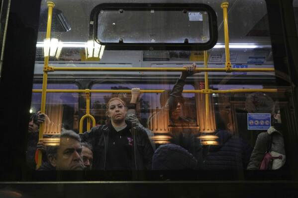 Commuters glance from a passing bus at the Basílica de San José de Flores, where the late Pope Francis worshipped as a youth, following the Vatican's announcement of his death in Buenos Aires, Argentina, Monday, April 21, 2025. (AP Photo/Rodrigo Abd)