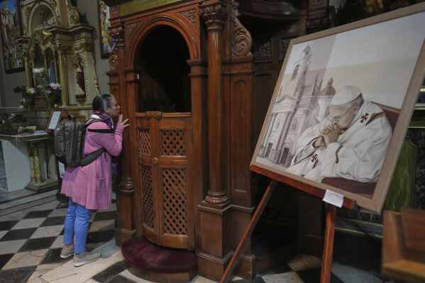 Alejandra Zuccoli prays at the Basílica de San José de Flores, the church where the late Pope Francis worshipped as a youth, following the Vatican's announcement of his death in Buenos Aires, Argentina, Monday, April 21, 2025. (AP Photo/Rodrigo Abd)