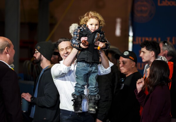 Conservative Leader Pierre Poilievre lifts his son Cruz up after speaking at a pre-election event in Ottawa, on March 21, 2025. (Justin Tang /The Canadian Press via AP, File)