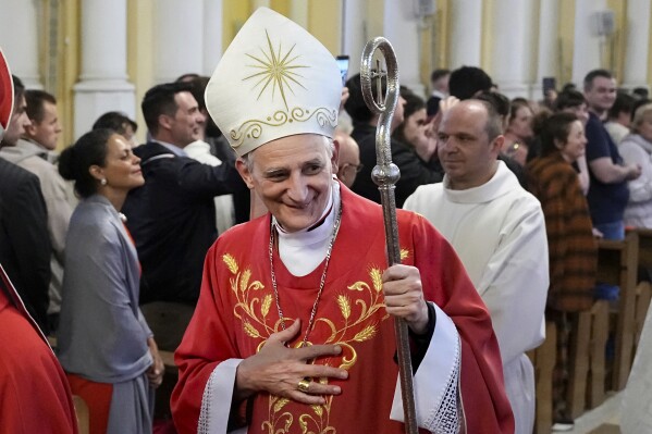 Cardinal Matteo Zuppi, head of the CEI (Italian Conference of Bishops), welcomes parishioners after celebrating Mass at the Cathedral of the Immaculate Conception in Moscow, on June 29, 2023. (AP Photo/Alexander Zemlianichenko, File)