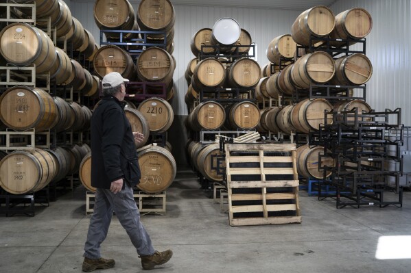 Scott Osborn, owner of Fox Run Vineyards, walks past wine barrels, Friday, March 21, 2025, in Penn Yan, N.Y. (Natasha Kaiser via AP)