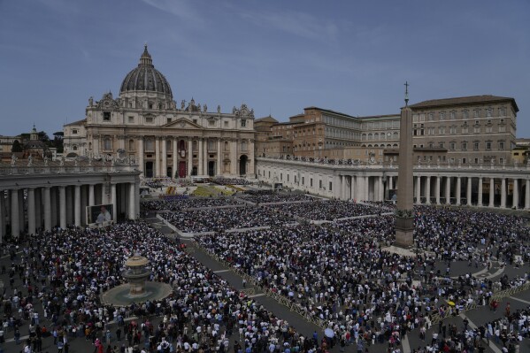 Faithful attend the Easter mass presided over by Cardinal Angelo Comastri in St. Peter's Square at the Vatican Sunday, April 20, 2025. (AP Photo/Gregorio Borgia)